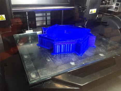 3d printer printing a blue prototype impeller